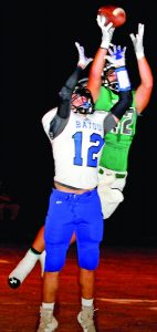 North Delta’s John Haga Lewis (back) had to haul down this pass over the Bayou defender Friday night. The Panolian photo by Andy Young