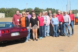 Members of the Corvette Club of Mississippi planned their October Ride to include a visit to the Cotton Warehouse Classic Cars and Farmers Market in Batesville last Saturday. Welcoming the Jackson-area Corvette enthusiasts were Linda Holland (sixth from left) and Danny Holland and Keith Ales (far right). The Panolian photo by Glennie Pou