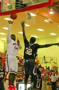 Robert Hentz goes up against against a Cleveland player as he attemps to dunk the ball. The Tigers cut it close with a 57-54 win Tuesday. South Panola will be back in action Nov. 28-Dec.1 in the Cleveland tournament. The Panolian Photo by Andy Young