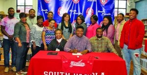 Demetrius Gleaton signed with the Nicholls State Colonels on Wednesday morning. Gleaton started two years for East Mississippi Community College. In his two years he help lead the Lions to a 19-2 record and a bowl victory. He started at offensive guard for the Lions. Seated with Gleaton are (seated left to right) Earnestine G. Pope, Gleaton, James Pope Jr. (standing l. to r.) Markel Gleaton, LuCretia Gleaton, Justin Pope, Lorrine Gleaton, Melissa Gleaton, Roosevelt Jones, Aerial Sanford, Whitney Gleaton, Tiffany Gleaton, ShaQuita Gleaton, Josefh Pope, and Undraius Blackburn The Panolian photo by Myra Bean