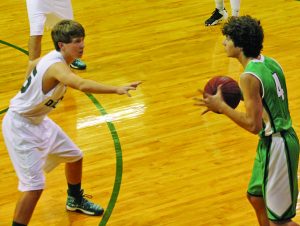 North Delta’s Avery Rowland (left) defends against the Clarksdale Lee ball handler in Monday night’s district action. The Green Wave won its first district game of the season, 51-36. The Panolian photo by Glennie Pou